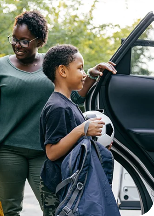 woman opening the car door for her kids