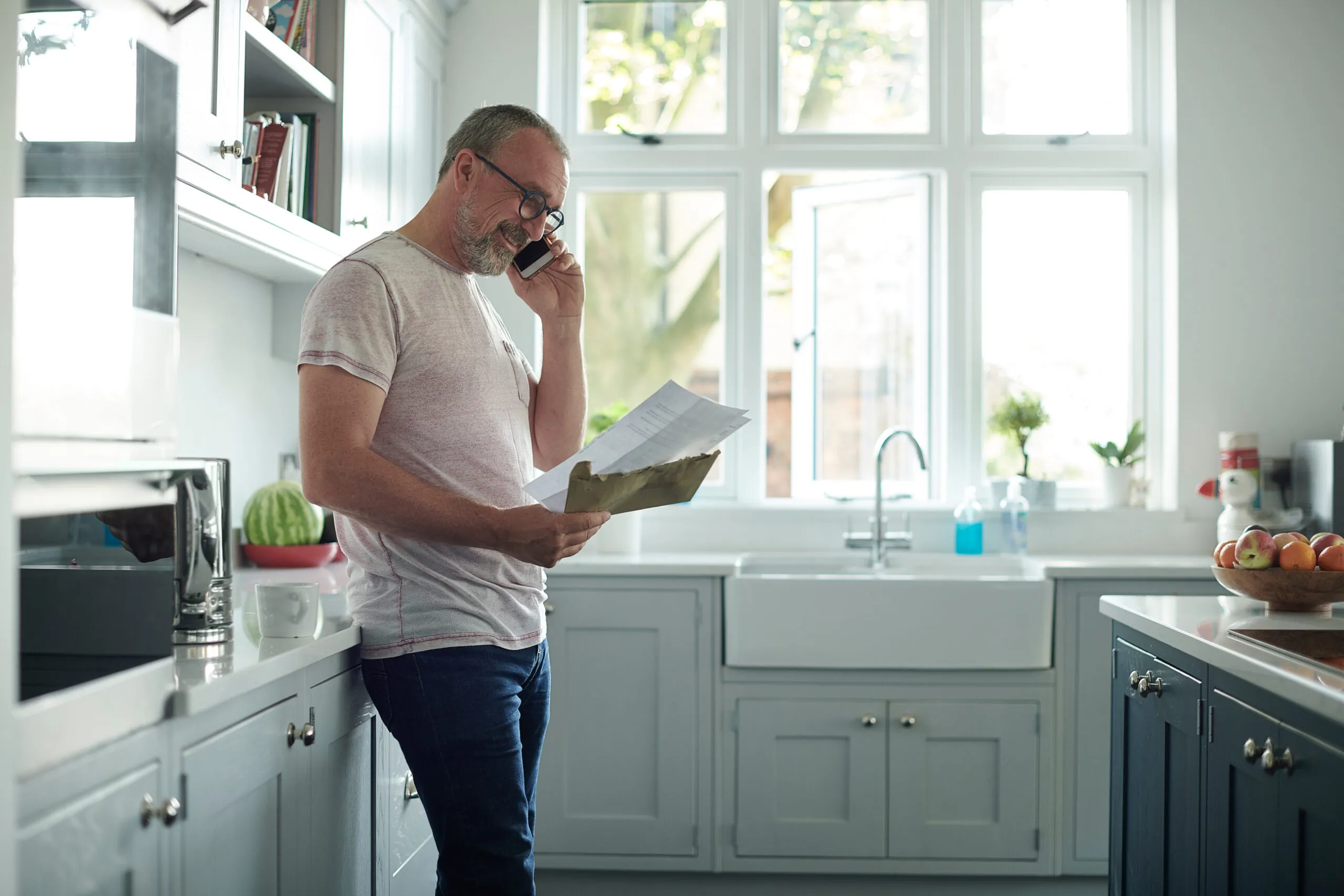 man looking at paper bills