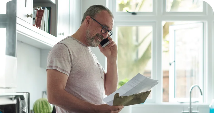 man looking at paper bill