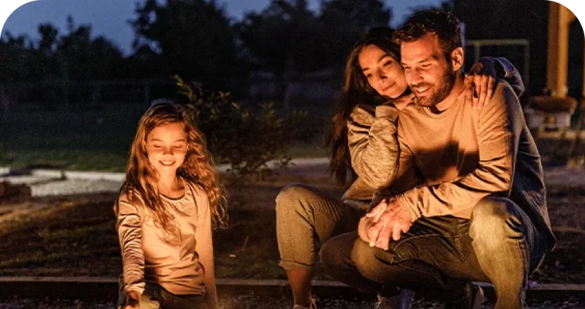 family sitting by a campfire